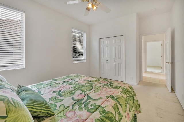 carpeted bedroom with a closet and a ceiling fan