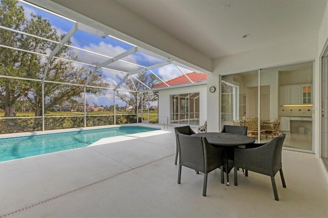 pool with glass enclosure and a patio area