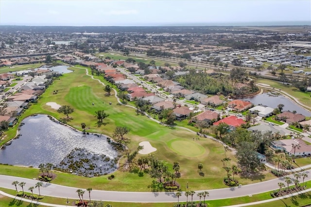 birds eye view of property with a water view, a residential view, and golf course view