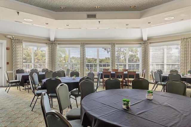 dining space featuring light carpet, visible vents, and crown molding