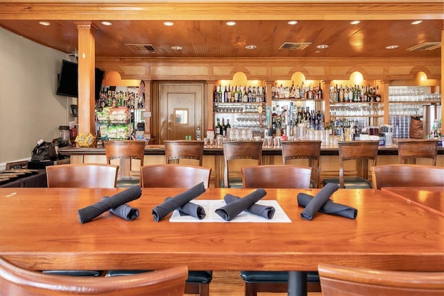 bar with a community bar, recessed lighting, wooden ceiling, and visible vents