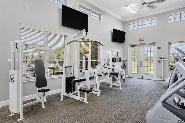 exercise room featuring french doors, a wealth of natural light, ornamental molding, carpet flooring, and baseboards
