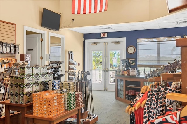 interior space with visible vents, a drop ceiling, and french doors