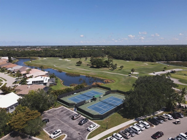 drone / aerial view with a water view and view of golf course