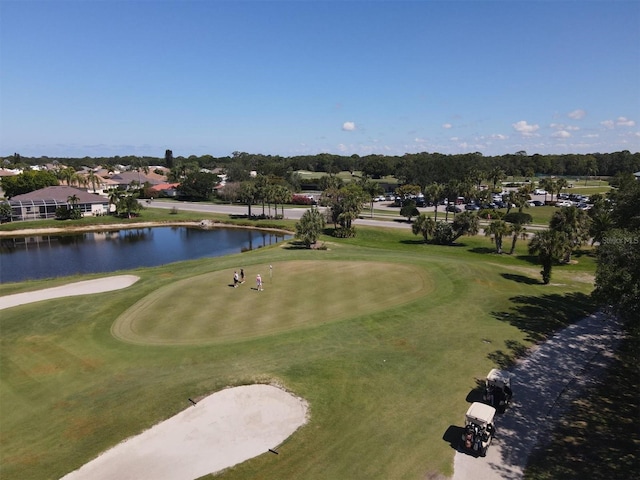 view of community featuring golf course view and a water view