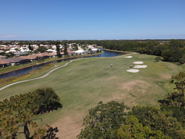 bird's eye view featuring golf course view, a water view, and a residential view