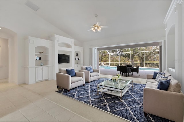 tiled living room featuring a sunroom, ceiling fan, carpet floors, built in shelves, and high vaulted ceiling