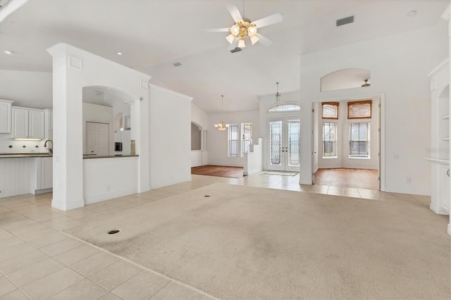 unfurnished living room featuring french doors, light carpet, visible vents, and light tile patterned floors