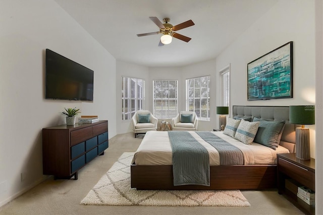 bedroom featuring light carpet and ceiling fan