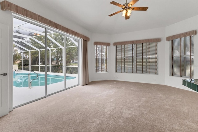 unfurnished sunroom featuring ceiling fan