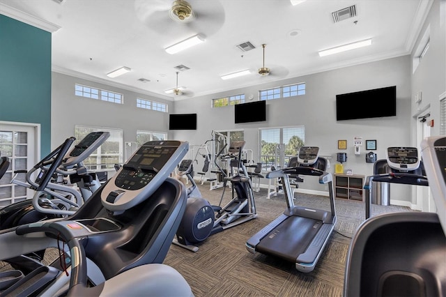 exercise room with visible vents and crown molding