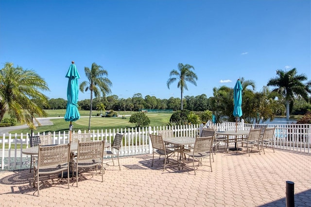 view of patio featuring outdoor dining space and fence