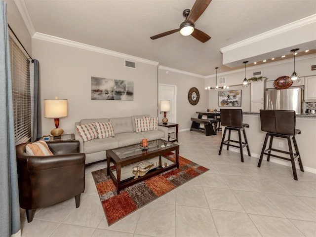 living area featuring light tile patterned floors, visible vents, and ornamental molding