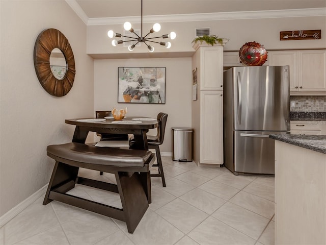 dining room with light tile patterned floors, visible vents, baseboards, crown molding, and a notable chandelier