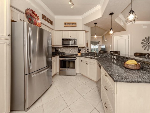 kitchen featuring dark stone countertops, decorative light fixtures, stainless steel appliances, crown molding, and a sink