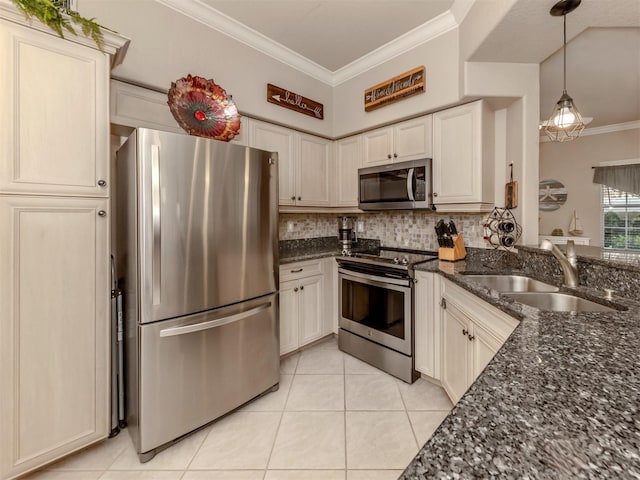 kitchen with crown molding, tasteful backsplash, appliances with stainless steel finishes, a sink, and dark stone countertops