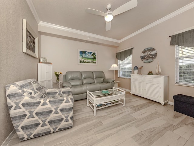 living room featuring baseboards, ornamental molding, and ceiling fan