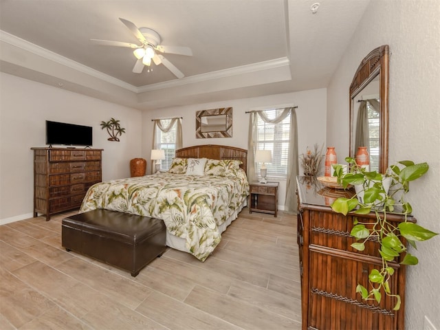 bedroom featuring a tray ceiling, multiple windows, crown molding, and wood finish floors