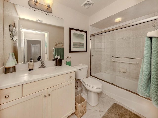 bathroom with tile patterned flooring, visible vents, shower / bath combination with glass door, and vanity