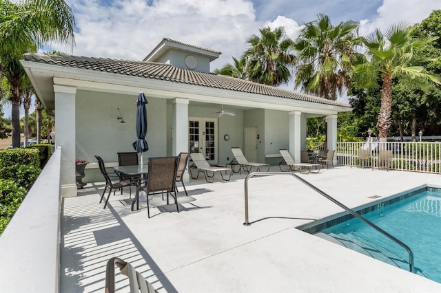 pool with fence, french doors, a ceiling fan, and a patio