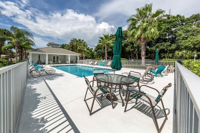 pool featuring a patio and fence