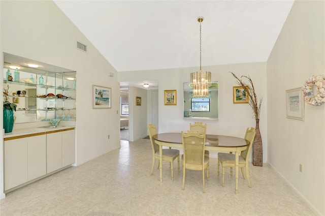 dining space with high vaulted ceiling and a notable chandelier