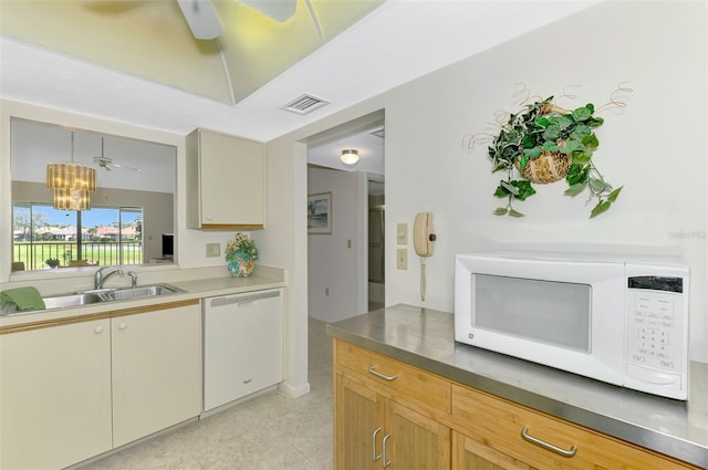 kitchen with ceiling fan with notable chandelier, sink, white appliances, and decorative light fixtures