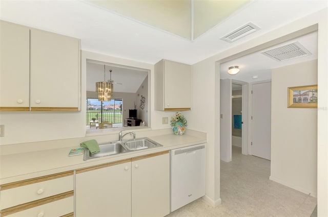 kitchen featuring hanging light fixtures, a notable chandelier, sink, vaulted ceiling, and white dishwasher