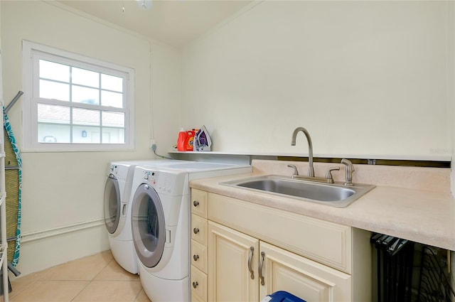 laundry room with light tile patterned floors, washer and clothes dryer, and a sink