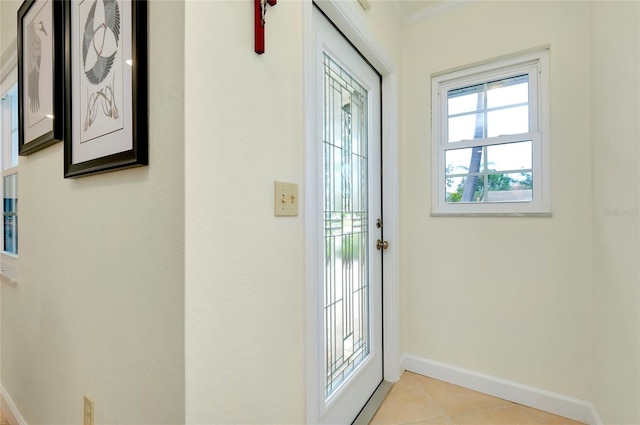 entryway with baseboards and light tile patterned floors