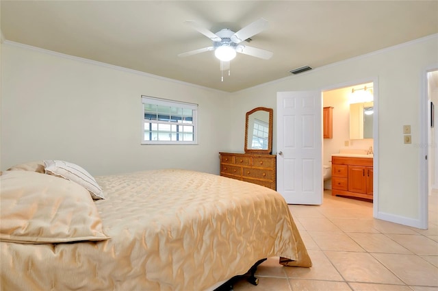 bedroom featuring light tile patterned floors, visible vents, ornamental molding, connected bathroom, and baseboards