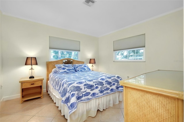 tiled bedroom featuring ornamental molding, visible vents, and baseboards