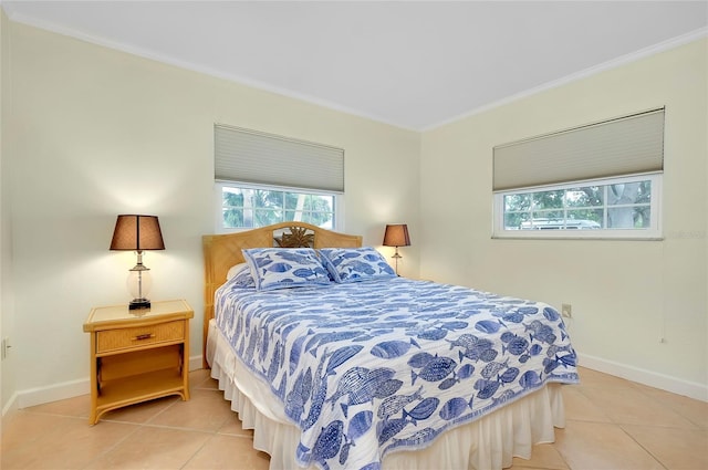 bedroom featuring crown molding, baseboards, and light tile patterned floors