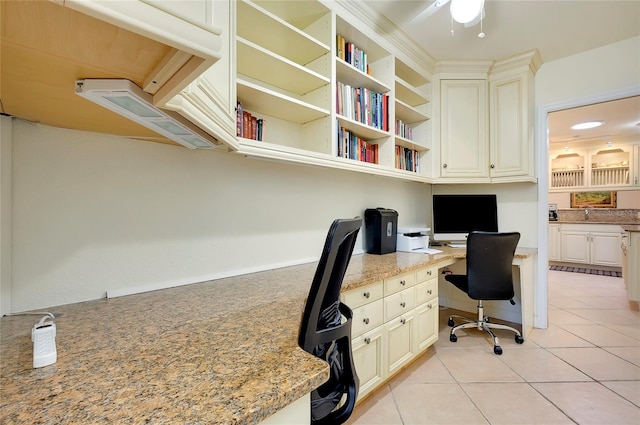 office area with light tile patterned flooring and built in study area