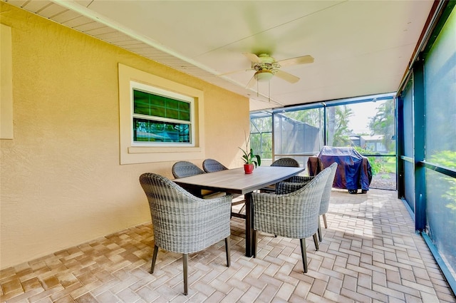 sunroom / solarium with a ceiling fan