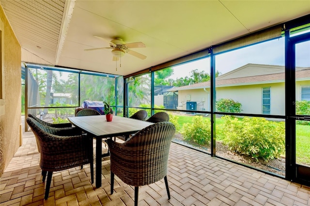 sunroom with a healthy amount of sunlight and ceiling fan