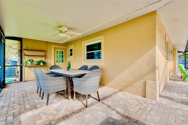 sunroom with ceiling fan