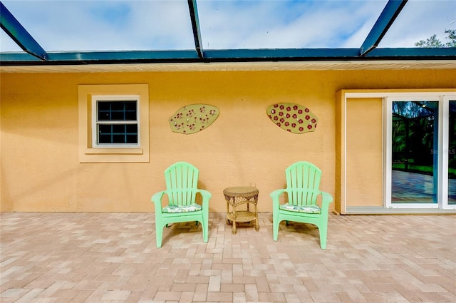 view of patio / terrace featuring a lanai