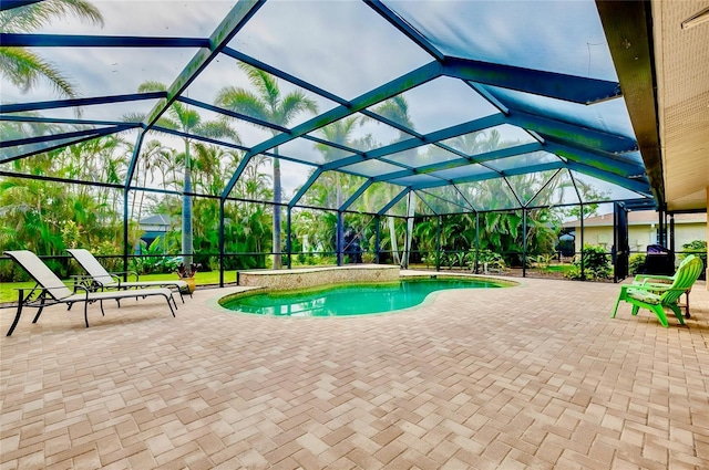 pool with glass enclosure and a patio area