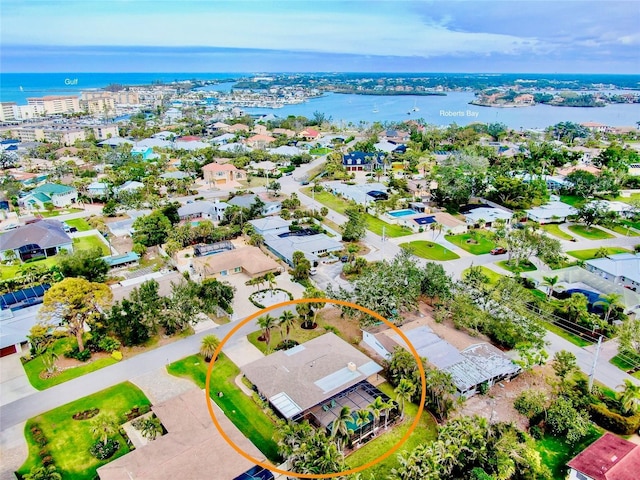 birds eye view of property with a water view and a residential view