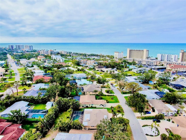 birds eye view of property with a water view and a city view