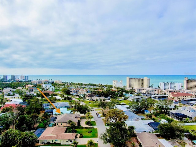 birds eye view of property with a water view and a view of city