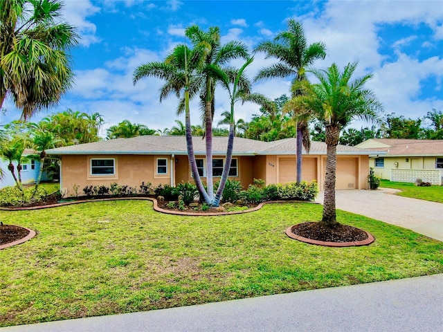 ranch-style house with a garage, stucco siding, driveway, and a front yard