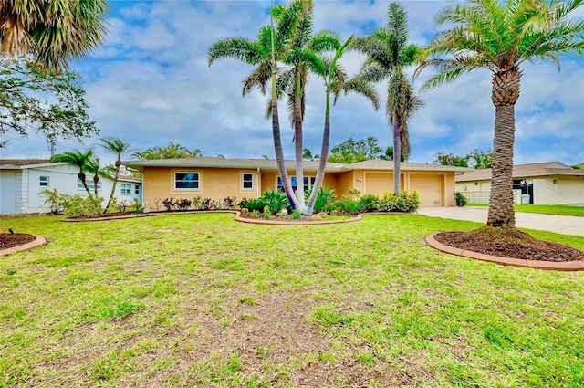 single story home with a garage, concrete driveway, a front lawn, and stucco siding