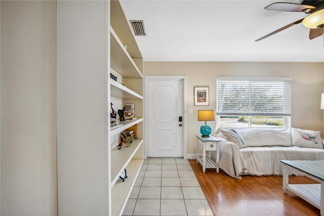 bedroom with ceiling fan, visible vents, baseboards, and light tile patterned flooring