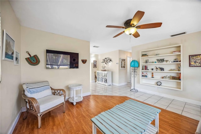 interior space with built in features, tile patterned flooring, visible vents, and baseboards