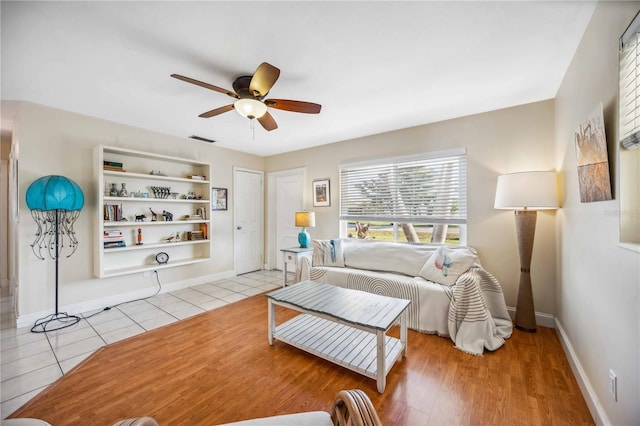 bedroom with visible vents, ceiling fan, baseboards, and light tile patterned floors