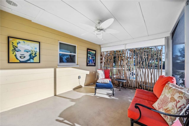 sunroom / solarium featuring ceiling fan