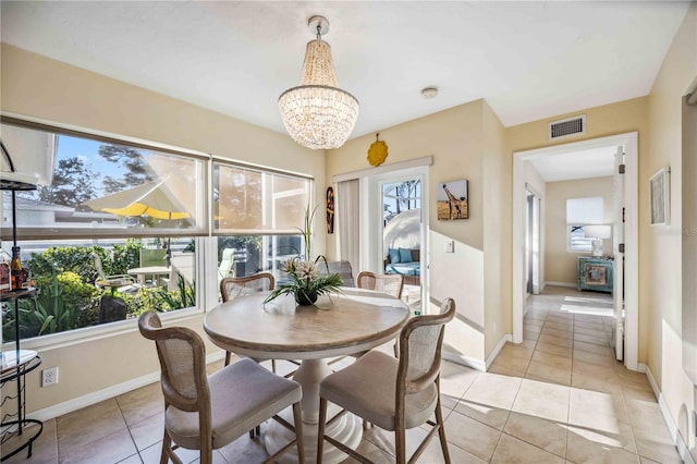 dining room featuring light tile patterned floors, a chandelier, visible vents, and baseboards