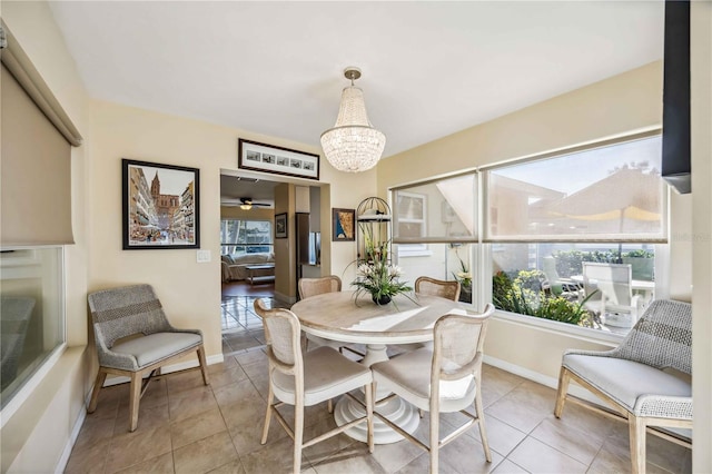 dining space featuring a notable chandelier, a wealth of natural light, and tile patterned floors